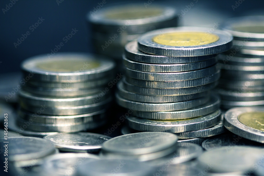 Close up silver money coin stacking on dark background Close up silver money coin stacking on dark background