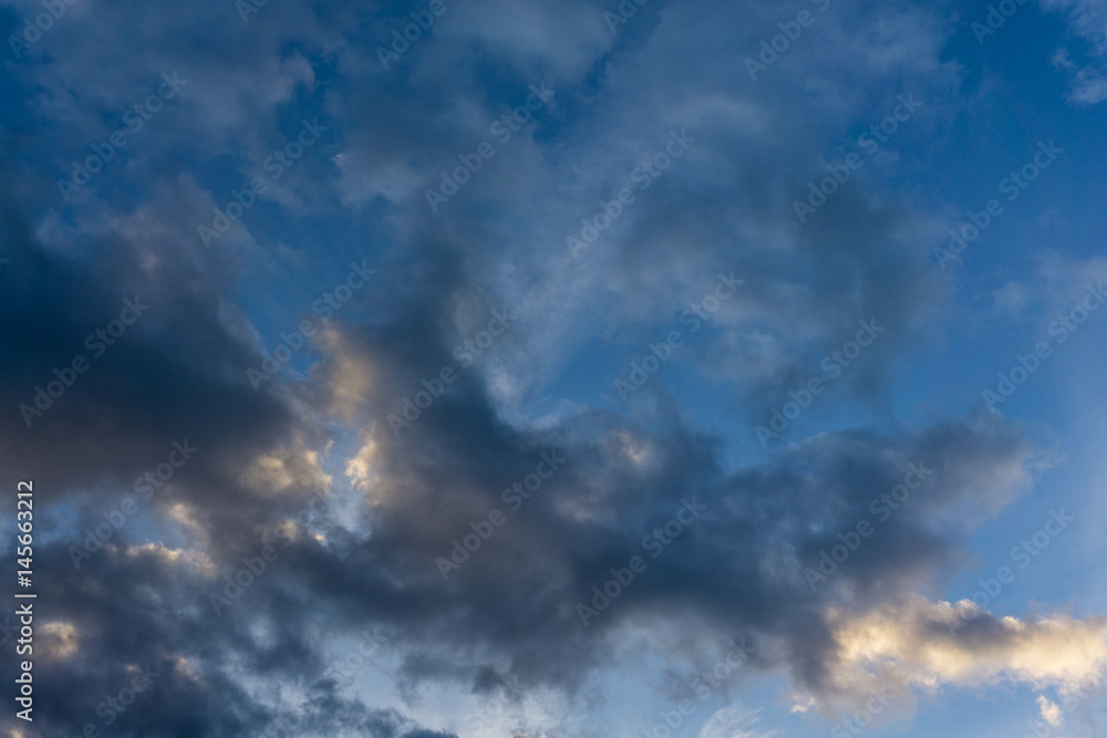 Blue sky with dark clouds as background