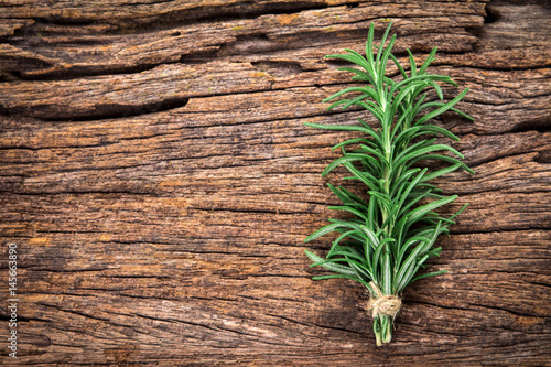 Fresh green Rosemary bound on a wooden board