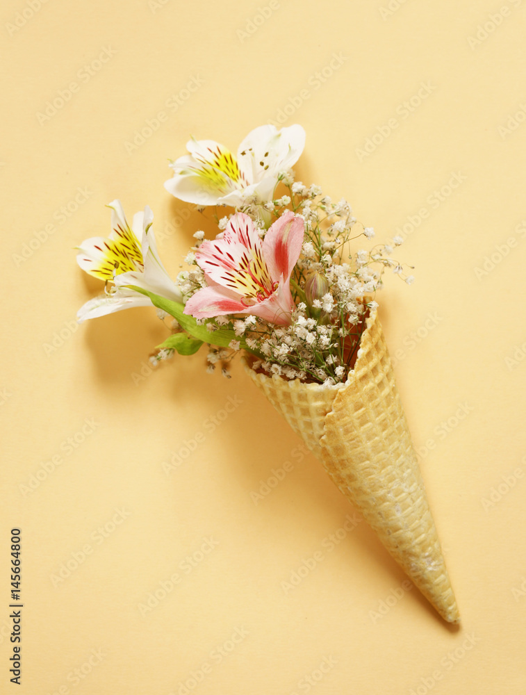 Fototapeta Waffle horn with spring flowers, vanilla style