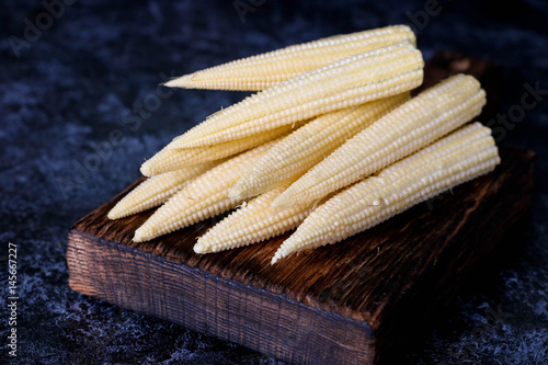 Baby corn cobs on kitchen table