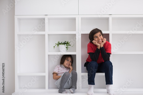 young boys posing on a shelf