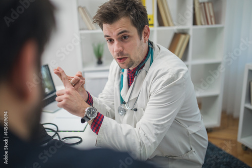 Patient and young doctor talking about patients problems