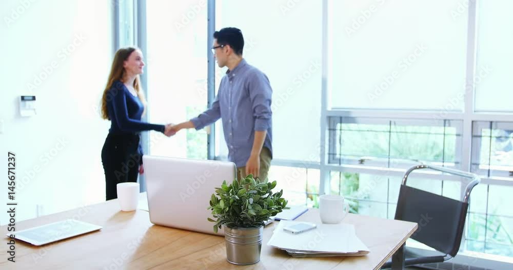 Business executives shaking hands with each other Business executives shaking hands with each other