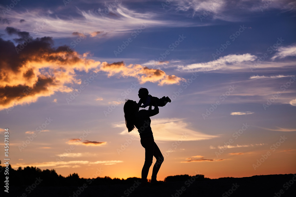 happy family playing on the sunset background. happy family playing on the sunset background.