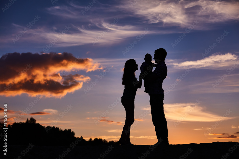 happy family playing on the sunset background