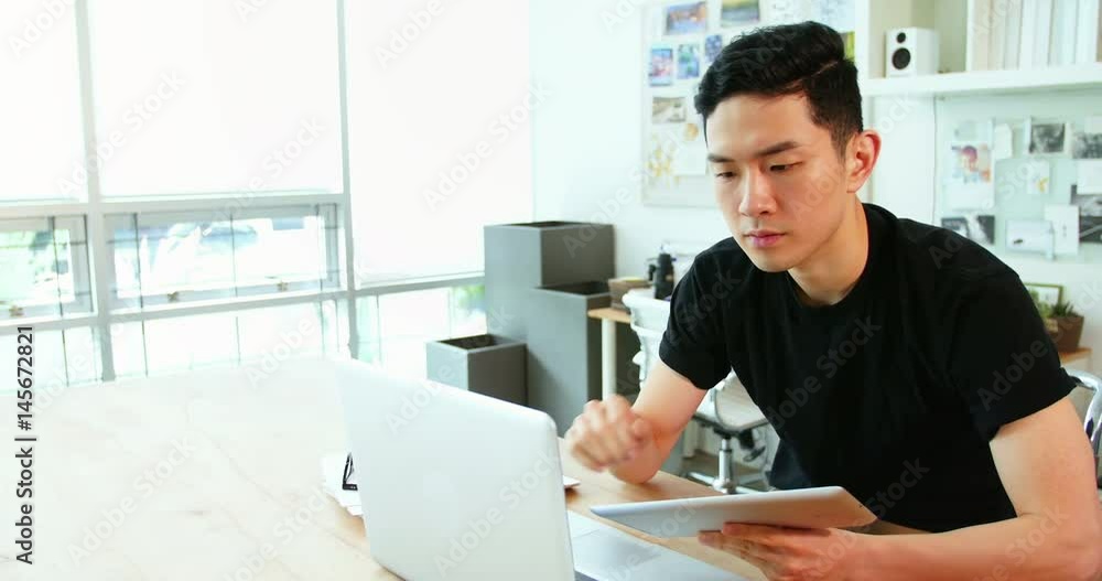Business executive using laptop and digital tablet Business executive using laptop and digital tablet