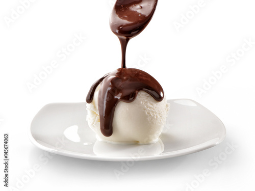 ice cream scoop on plate close-up with melted flowing down chocolate isolated on white background
