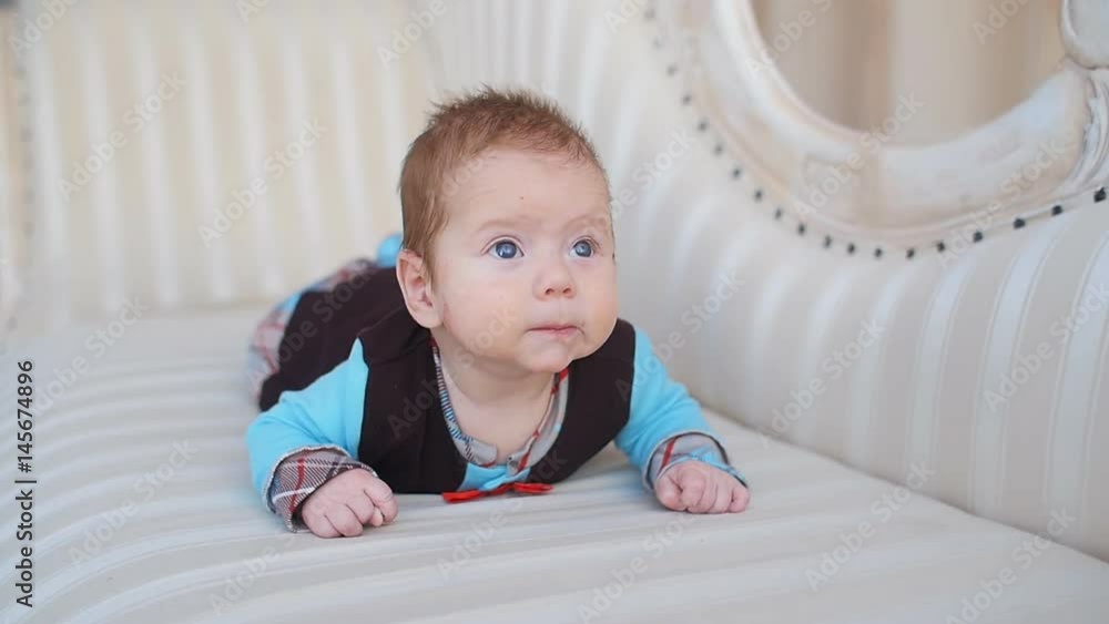 Infant lies on the sofa Infant lies on the sofa