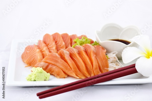 Salmon fish with sauce and wasabi on white dish