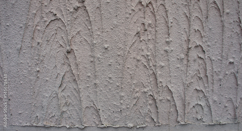 Texture - the wall is covered with light gray coarse plaster.