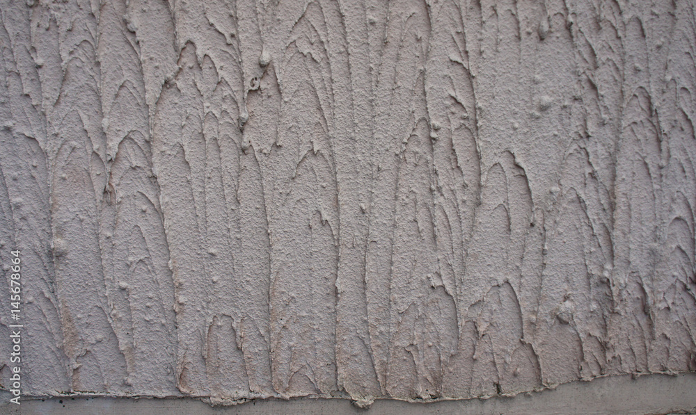 Texture - the wall is covered with light gray coarse plaster.