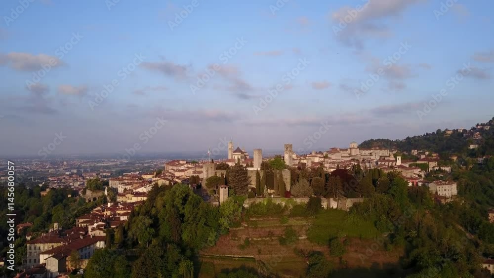 Drone aerial view of Bergamo - Old city (upper town), Italy. Landscape on the city center, the old fortress and its historical buildings during a wonderful blu day Drone aerial view of Bergamo - Old city (upper town), Italy. Landscape on the city center, the old fortress and its historical buildings during a wonderful blu day