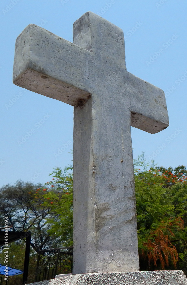 Empty headstone or gravestone against blue sky in a Christian Cemetery