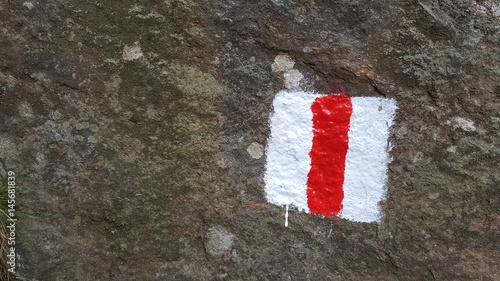 Tourist sign on the stone in the mountains