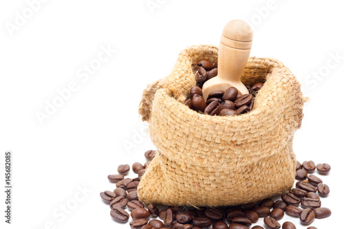 Organic coffee beans in sack on white background close up isolated.(Droped space on left side for text and other.)