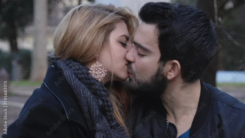 Beautiful couple kissing sweetly outdoor, portrait Beautiful couple kissing sweetly outdoor, portrait