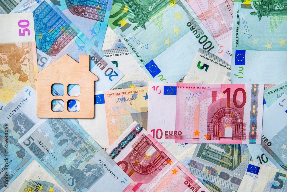 The symbol of the house lies on the background of the Euro The symbol of the house lies on the background of the Euro