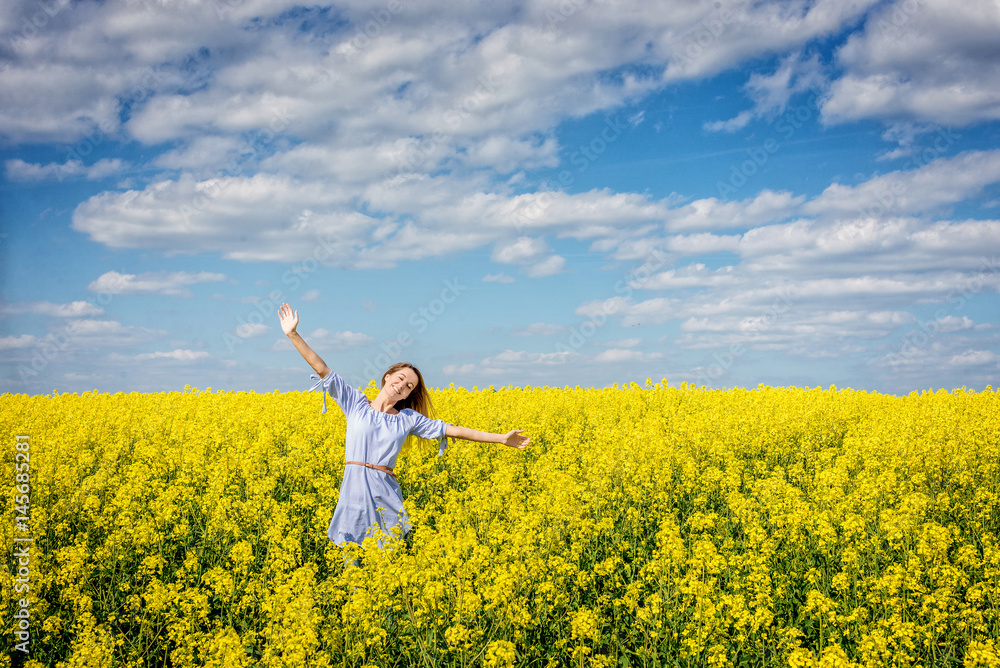 Carefree woman in rapeseed field Carefree woman in rapeseed field