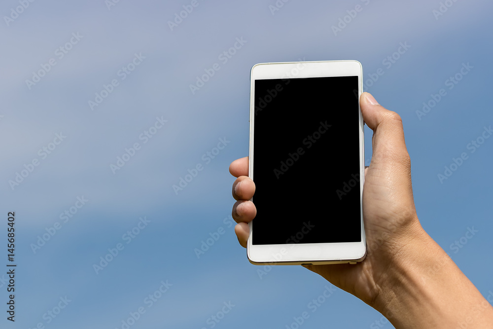 Hand holding a smartphon on blurred background