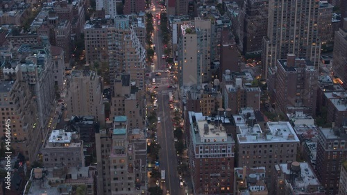 AERIAL HELI SHOT: Flying above the rooftops of low-rise blocks of flats, high-rise towers, houses, apartment buildings and condominiums in residential area of New York City on early summer morning