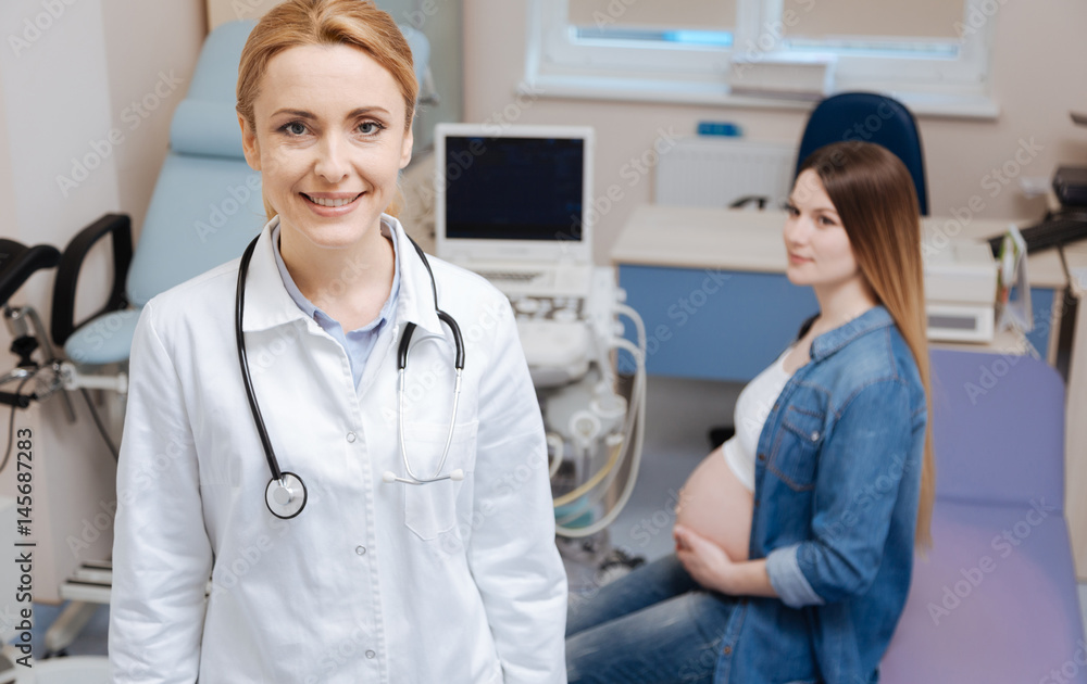 Delighted practitioner enjoying appointment hours in the clinic Delighted practitioner enjoying appointment hours in the clinic