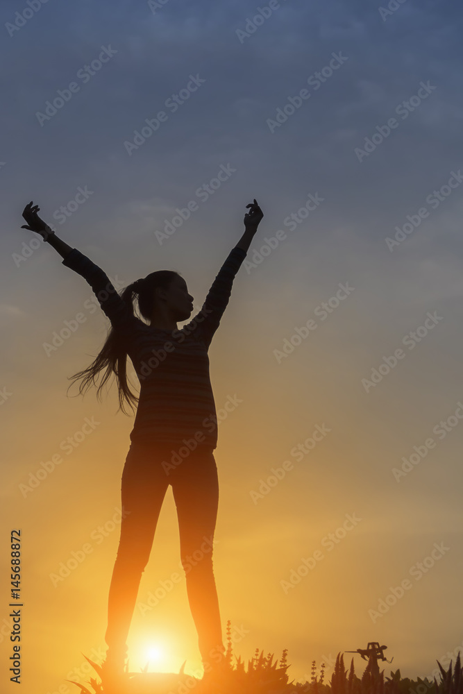 silhouette of a happy woman and sunset