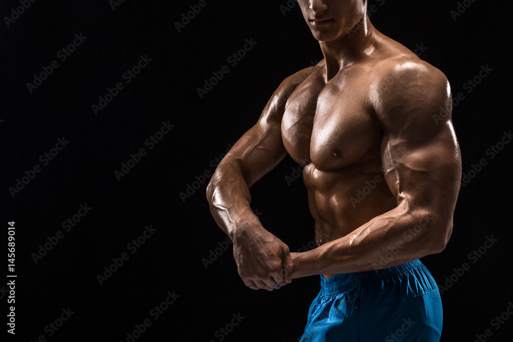 Fototapeta premium Part of a man's body on a dark background with copyspace