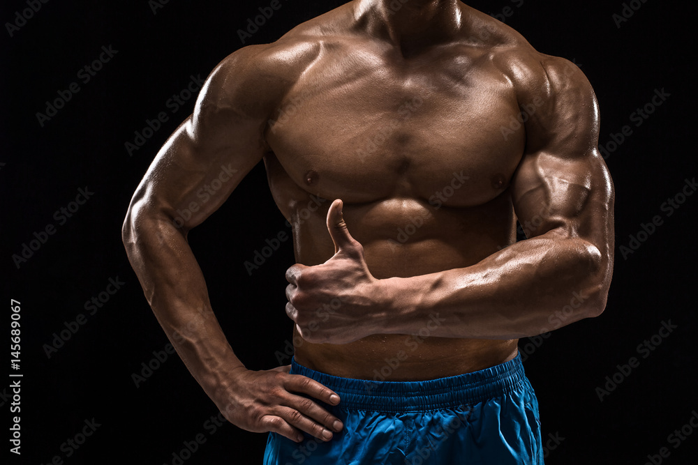 Fototapeta premium Part of a man's body on a dark background with copyspace