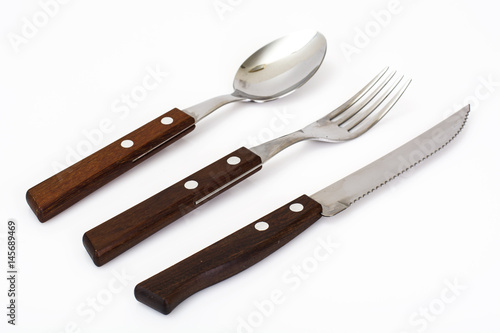 Cutlery with wooden handles on white background