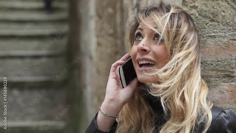 Close up on Charming woman talking on the phone smiling Close up on Charming woman talking on the phone smiling