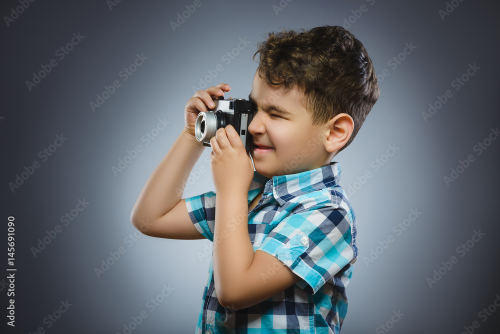 child taking a picture using a retro rangefinder camera isolated grey background child taking a picture using a retro rangefinder camera isolated grey background