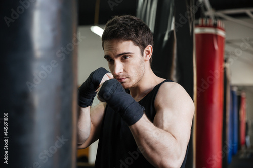 Boxer training with punching bag © Drobot Dean