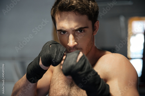 Young man boxer looking camera with hands © Drobot Dean