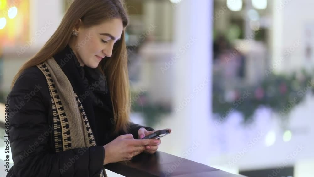 Brilliant eastern-europian girl with brown hair trying to chat with her friend in huge and beatiful shopping mall, Steady cam, slow mo shot Brilliant eastern-europian girl with brown hair trying to chat with her friend in huge and beatiful shopping mall, Steady cam, slow mo shot