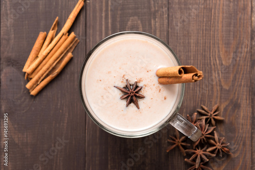 Masala chai with spices cinnamon , cardamom, ginger, clove and star anise on wooden background