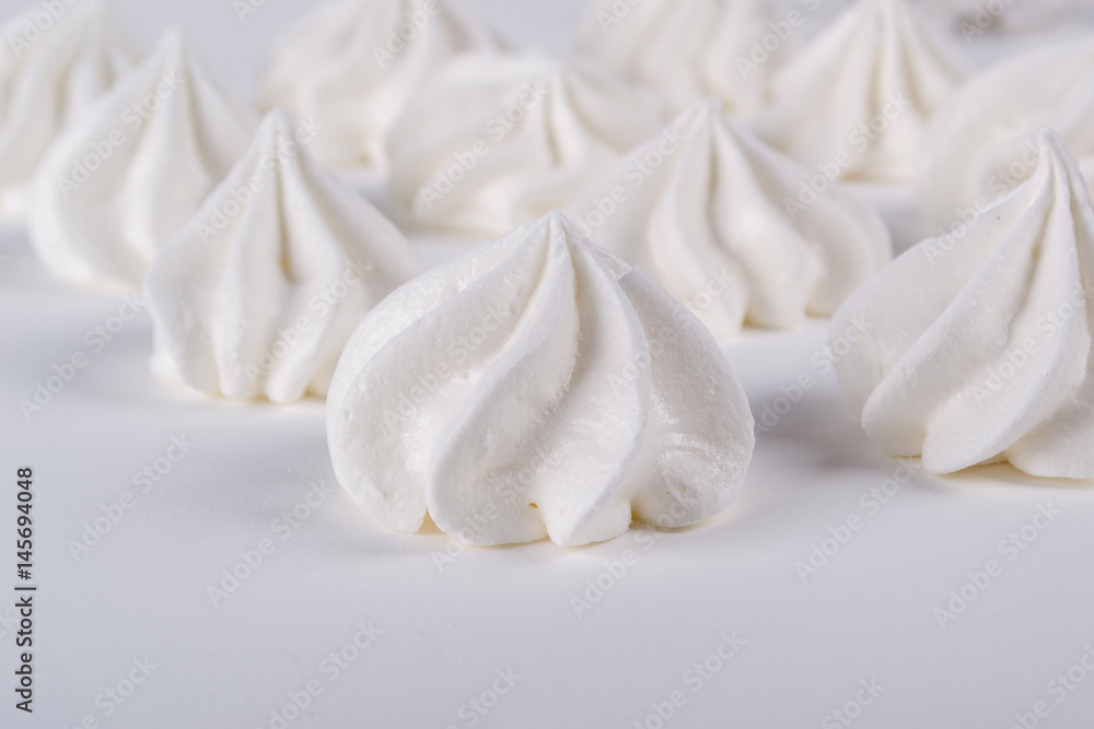 Meringue cookies blur. Soft selective focus.  Background  with blurry mini meringues cookies. Closeup