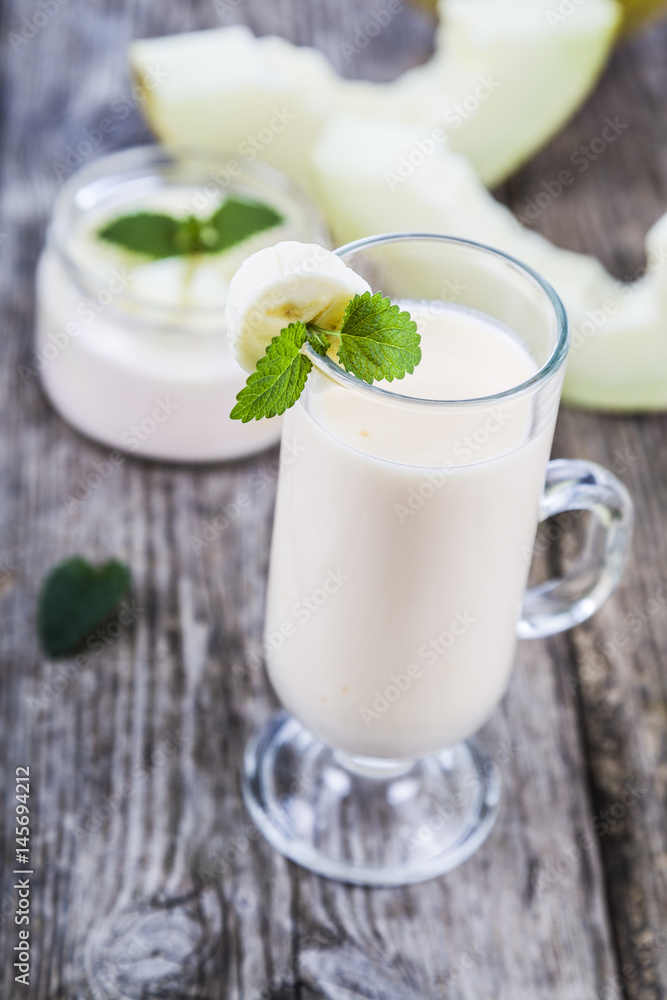 Yogurt and smoothie with melon on a wooden table. Yogurt and smoothie with melon on a wooden table.