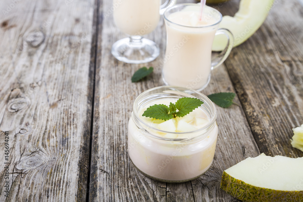 Yogurt and smoothie with melon on a wooden table. Yogurt and smoothie with melon on a wooden table.