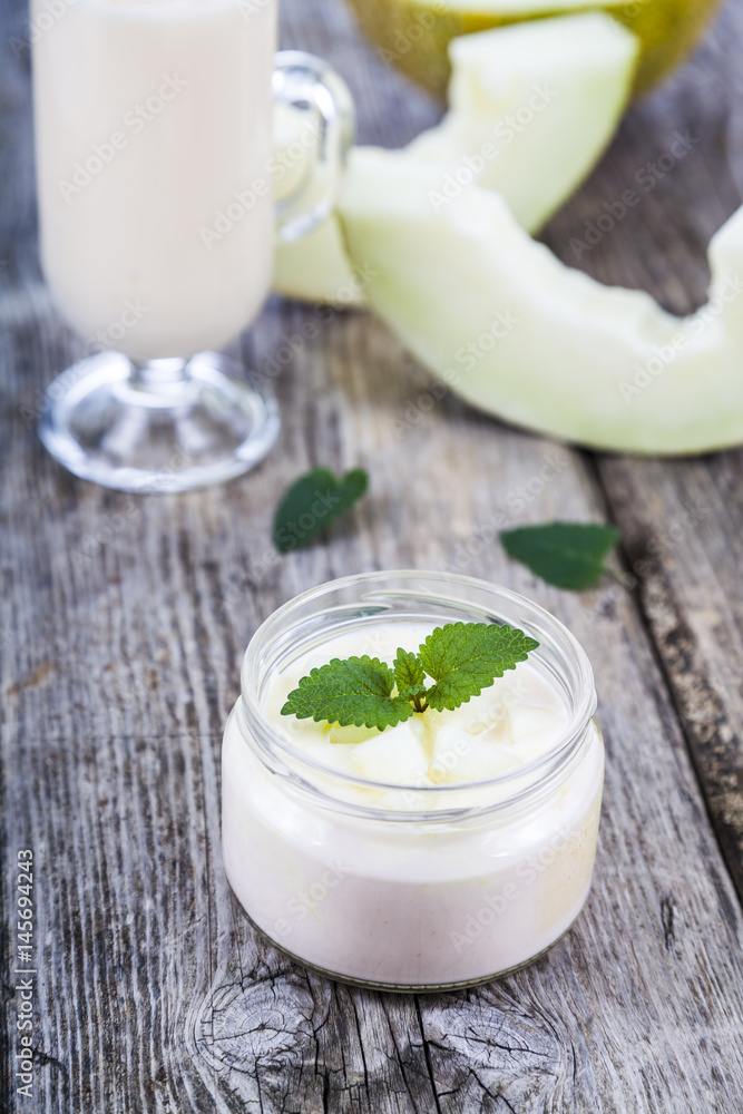 Yogurt and smoothie with melon on a wooden table. Yogurt and smoothie with melon on a wooden table.