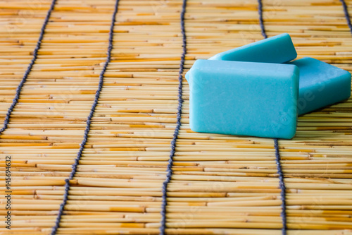 Billede på lærred Blue soap on bamboo mat