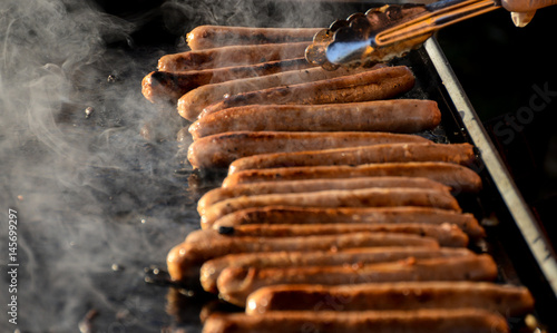 Sausages sizzling on hot barbecue