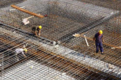 worker in the construction site making reinforcement metal framework for concrete pouring