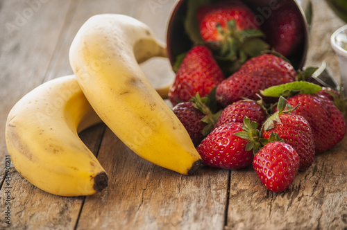 strawberry banana fruits on wood table