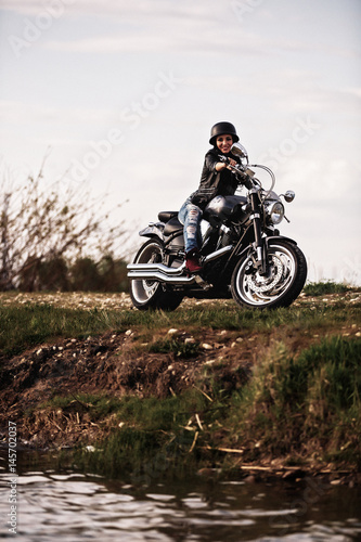 Fototapeta Naklejka Na Ścianę i Meble -  Beautiful brunette woman with a classic motorcycle (cinema bleach bypass effect)