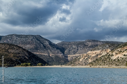 landscape with the sea and mountains and thick dark clouds