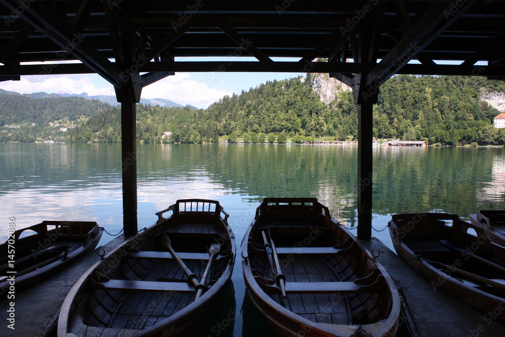 Bled lake in Slovenia. Notice the amazing color of water with boats in dark area