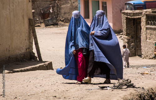 Afghan women in burqas walking in the street in Kabul photo