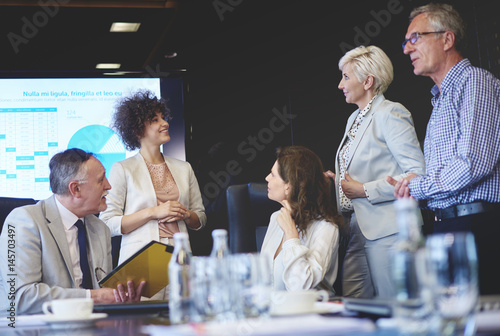 Five business people in conference room
