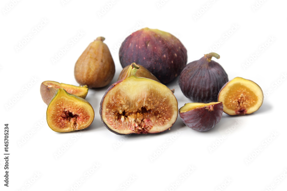 Several varieties of common fig fruits cut open showing the flesh on white background. Several varieties of common fig fruits cut open showing the flesh on white background.